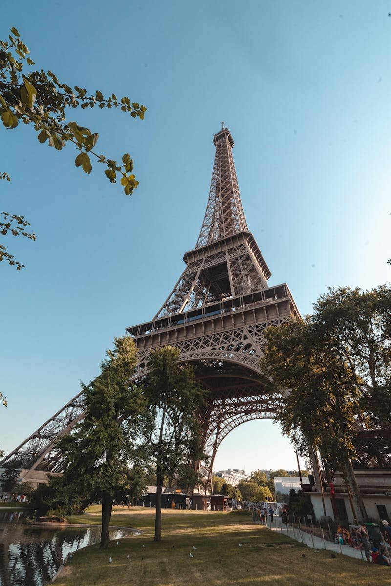 Iconic view of the Eiffel Tower, Paris under a blue sky, ideal for travel inspiration.