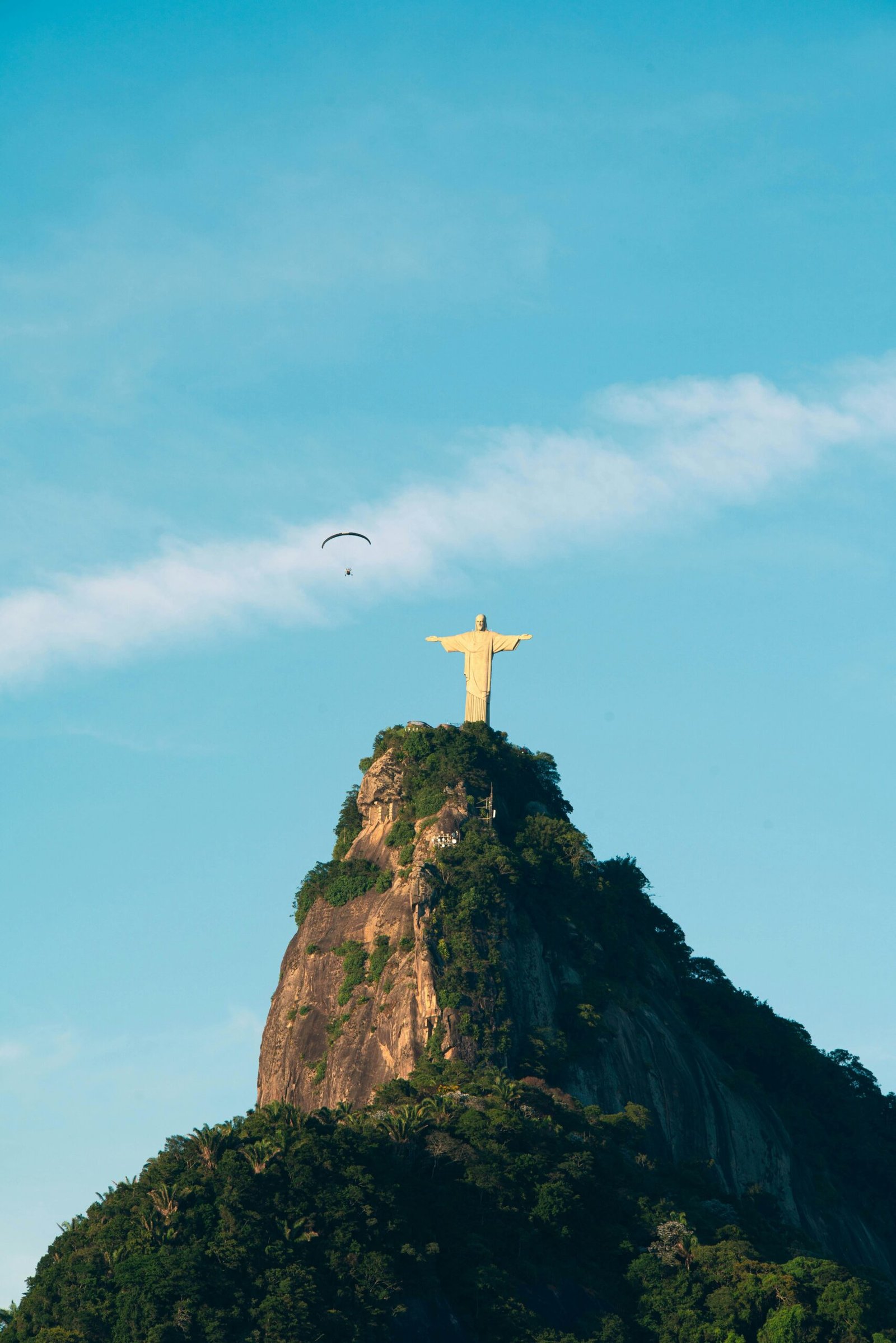 Dramatic view of Christ the Redeemer statue atop Corcovado Mountain at sunrise in Rio de Janeiro, Brazil.